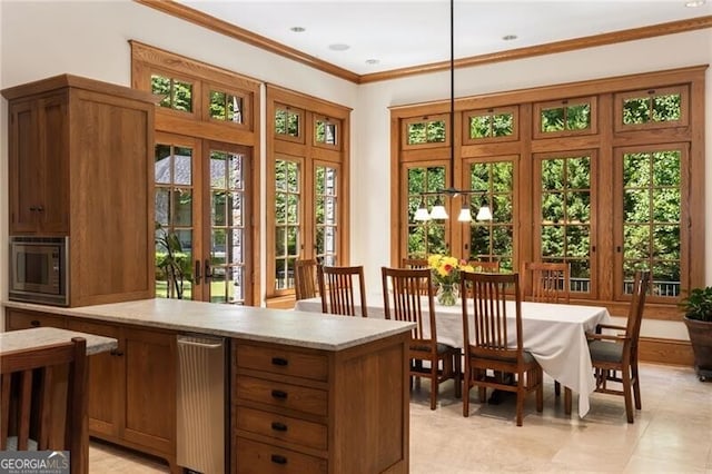 interior space with french doors, decorative light fixtures, stainless steel microwave, and ornamental molding