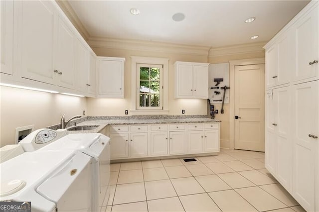 laundry room featuring sink, cabinets, light tile patterned floors, washer and dryer, and ornamental molding