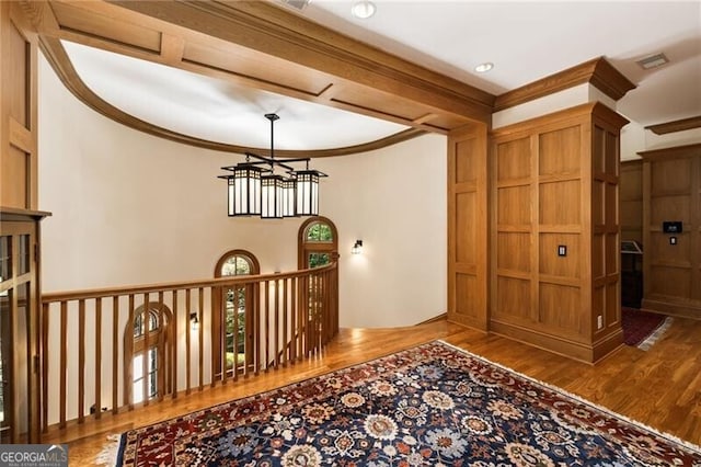 hall with hardwood / wood-style flooring and crown molding