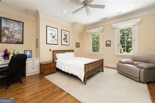 bedroom featuring ceiling fan, light hardwood / wood-style flooring, and ornamental molding