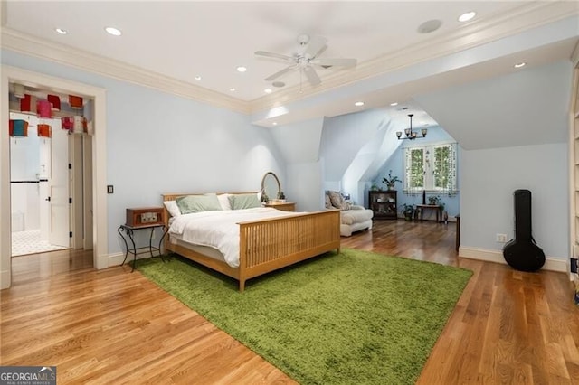 bedroom featuring ceiling fan, crown molding, and hardwood / wood-style flooring