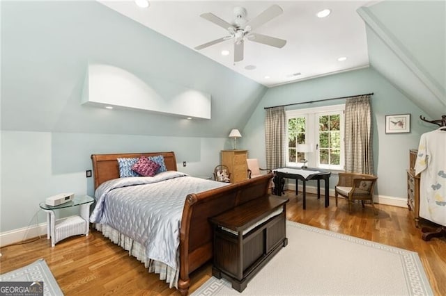 bedroom with ceiling fan, vaulted ceiling, and hardwood / wood-style flooring