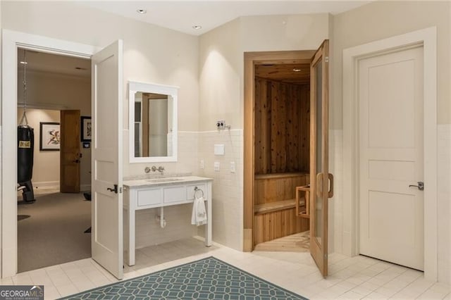 bathroom featuring tile patterned flooring, vanity, and tile walls