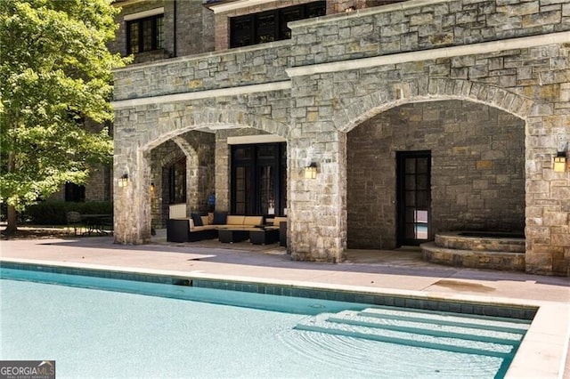 view of swimming pool with a patio area and an outdoor hangout area