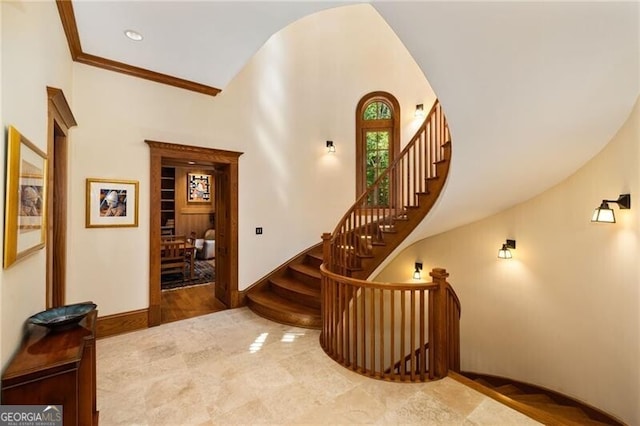 staircase featuring ornamental molding