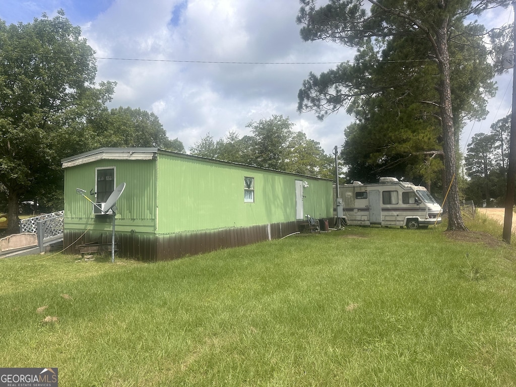 view of side of property with a yard