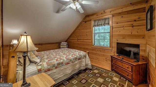 bedroom featuring wood walls, vaulted ceiling, dark hardwood / wood-style flooring, and ceiling fan