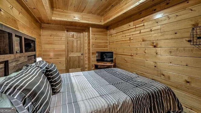 bedroom featuring wood ceiling and wooden walls