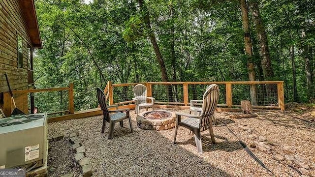 view of patio featuring an outdoor fire pit and central AC unit