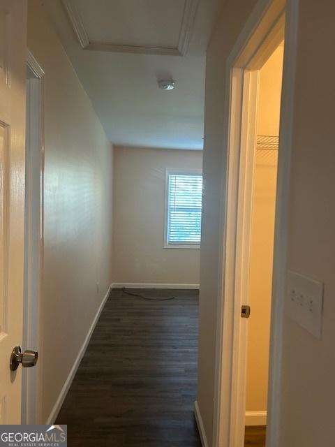 corridor featuring dark hardwood / wood-style flooring and ornamental molding