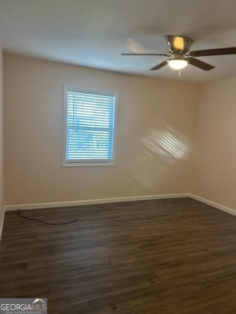 unfurnished room featuring dark hardwood / wood-style flooring and ceiling fan