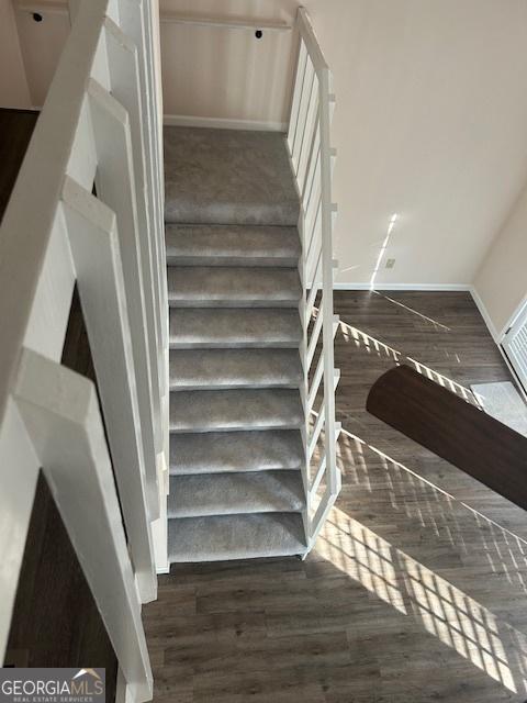 stairs featuring hardwood / wood-style flooring