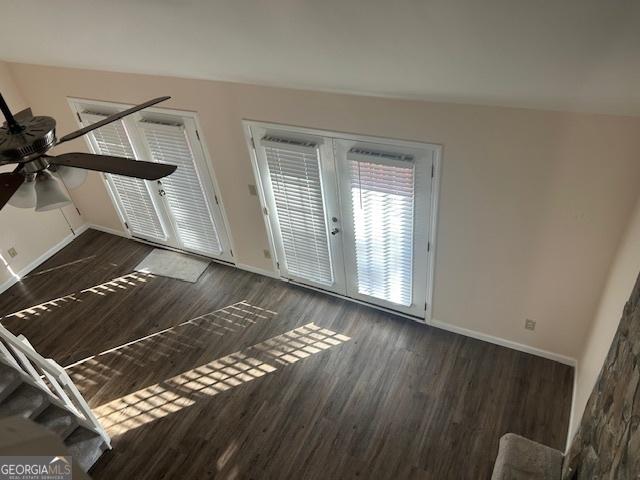 interior space featuring ceiling fan, french doors, and dark wood-type flooring