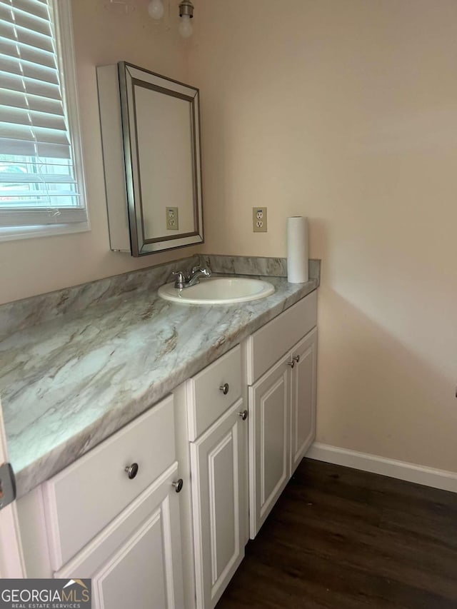 bathroom with vanity and wood-type flooring