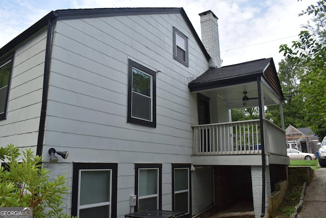 view of side of property with ceiling fan