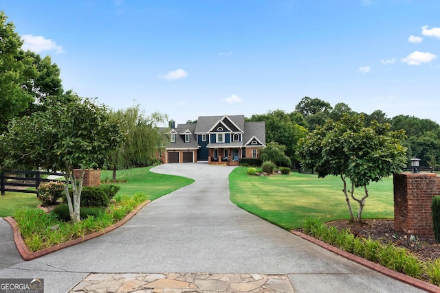 view of front of home with a garage and a front lawn