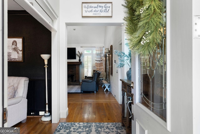 entrance foyer with dark hardwood / wood-style floors and a fireplace