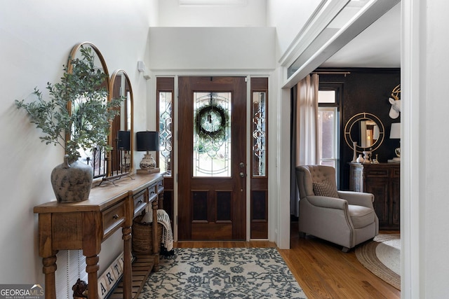 entryway featuring light hardwood / wood-style flooring and a high ceiling