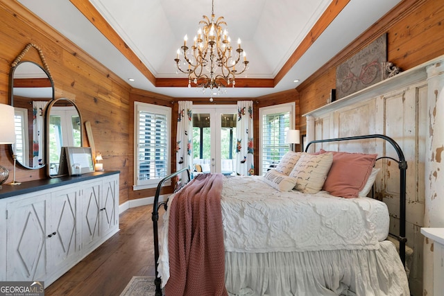 bedroom with french doors, crown molding, access to outside, a tray ceiling, and dark hardwood / wood-style flooring