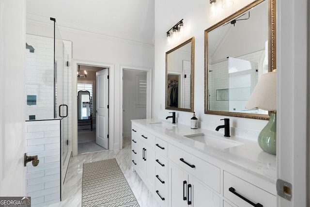 bathroom featuring crown molding, vanity, and walk in shower