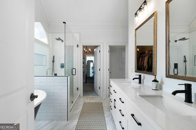 bathroom with crown molding, vanity, a chandelier, and a shower with shower door