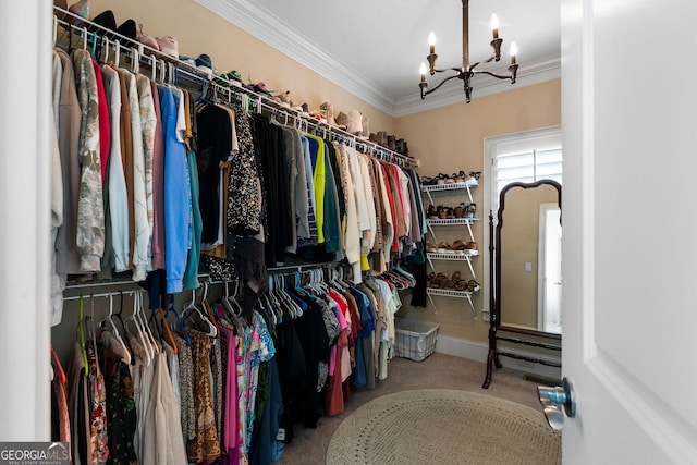 walk in closet featuring an inviting chandelier and carpet floors