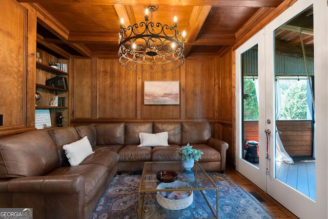 living room with wood ceiling, built in features, french doors, beamed ceiling, and wood walls