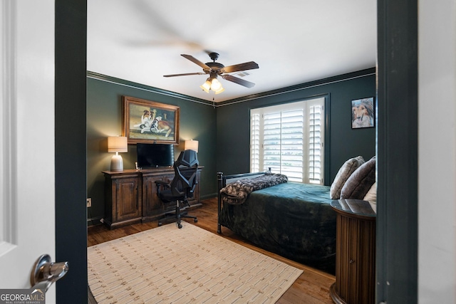 bedroom featuring hardwood / wood-style flooring and ceiling fan