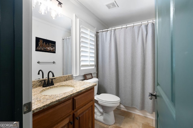 bathroom with ornamental molding, vanity, and toilet