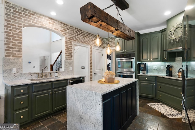 kitchen with a center island, sink, stainless steel double oven, and green cabinets