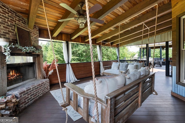 wooden deck featuring an outdoor living space with a fireplace and ceiling fan