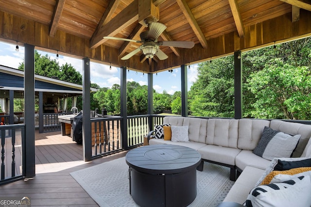 sunroom / solarium featuring lofted ceiling with beams, ceiling fan, and wood ceiling