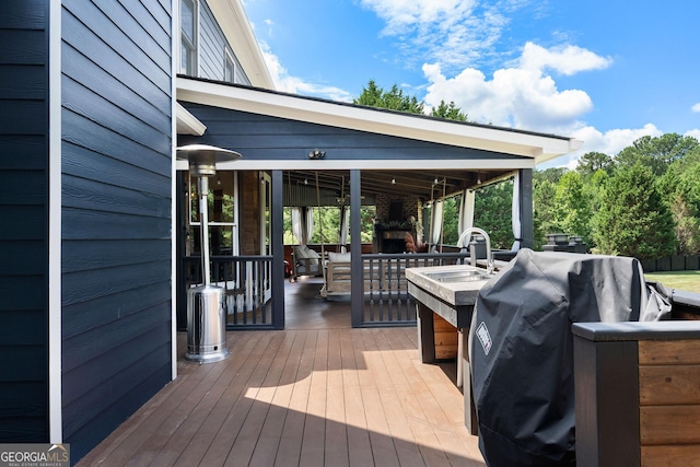 wooden terrace with area for grilling and sink