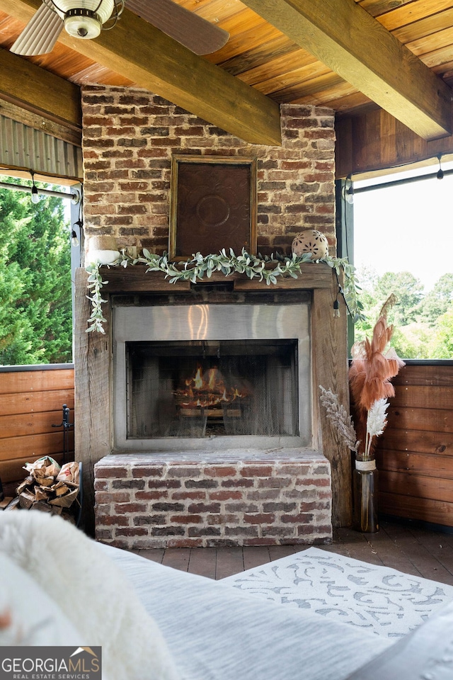 details featuring beam ceiling, a brick fireplace, and wood ceiling