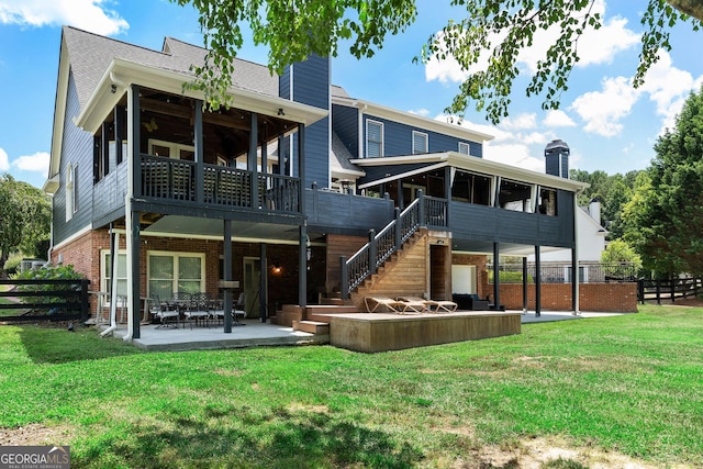 rear view of property featuring a yard and a patio