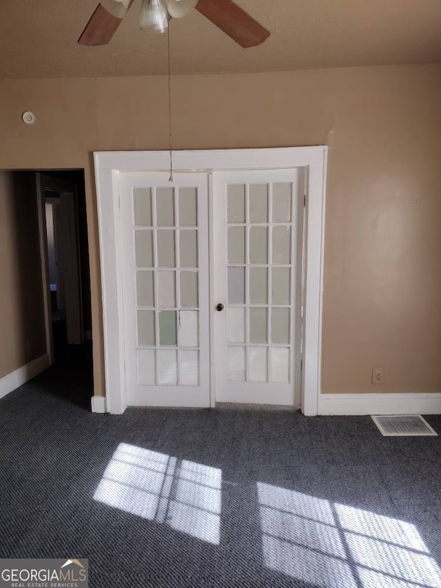 carpeted empty room featuring french doors