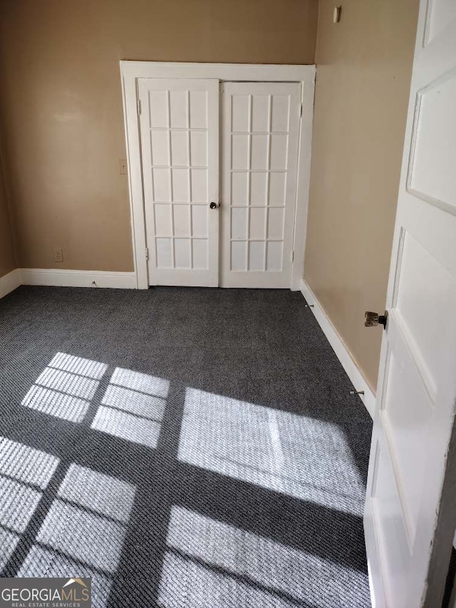 unfurnished bedroom featuring carpet floors and a closet