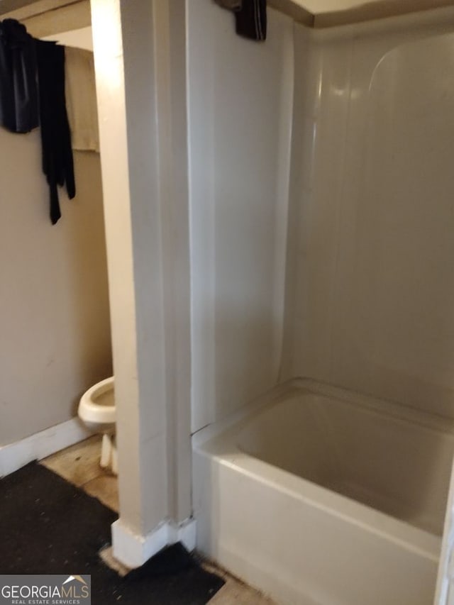 bathroom featuring toilet and shower / washtub combination