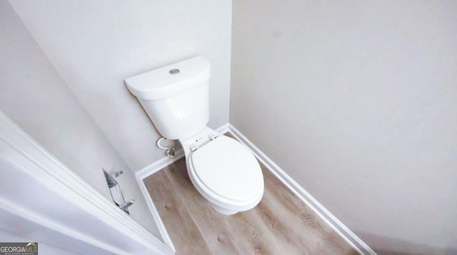 bathroom featuring hardwood / wood-style flooring and toilet