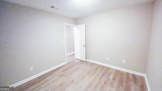 unfurnished room with light wood-type flooring