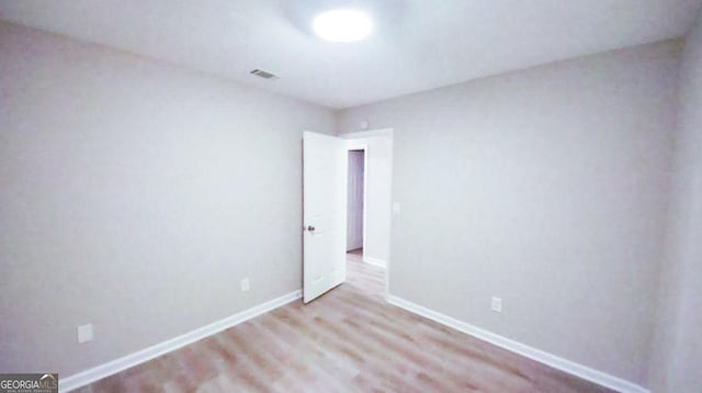 spare room with light hardwood / wood-style flooring