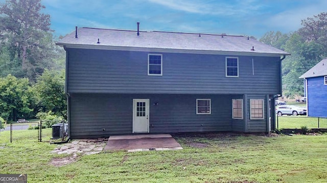 back of property featuring cooling unit, a patio area, and a lawn