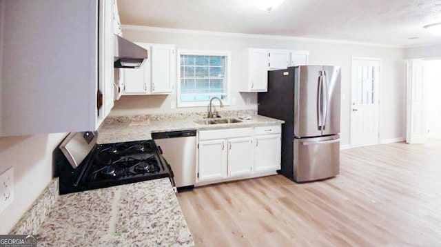 kitchen with stainless steel appliances, a textured ceiling, white cabinets, and sink