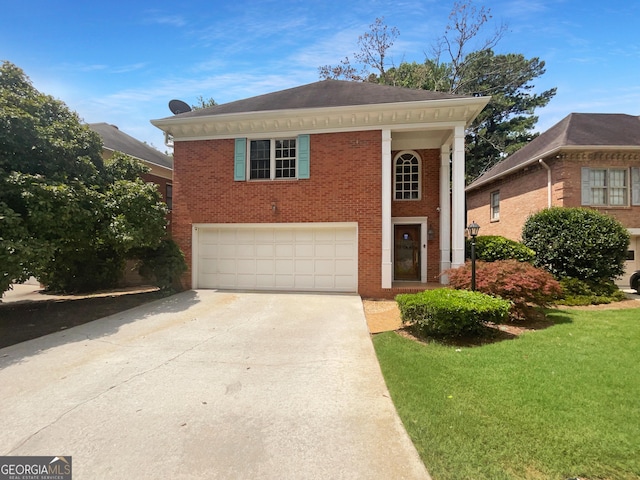 view of front of property featuring a garage and a front lawn