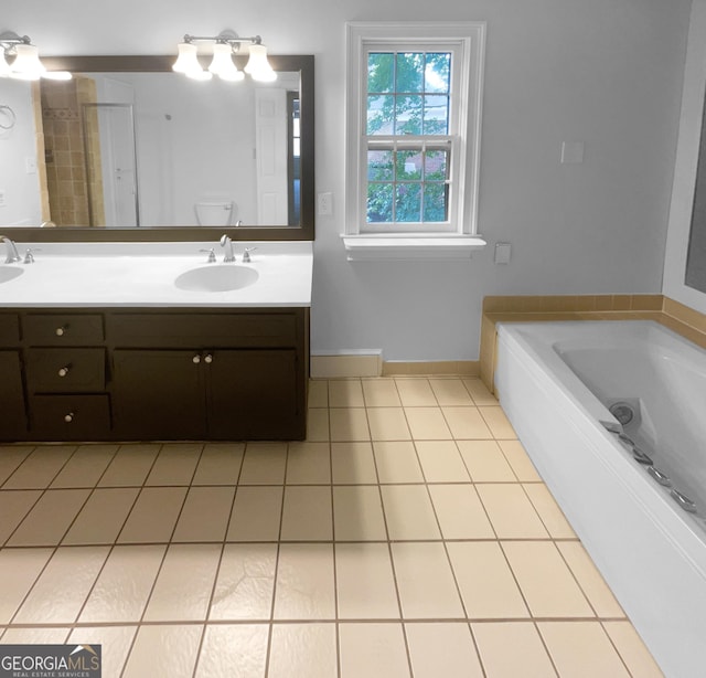 bathroom with tile patterned flooring, vanity, toilet, and a bathing tub