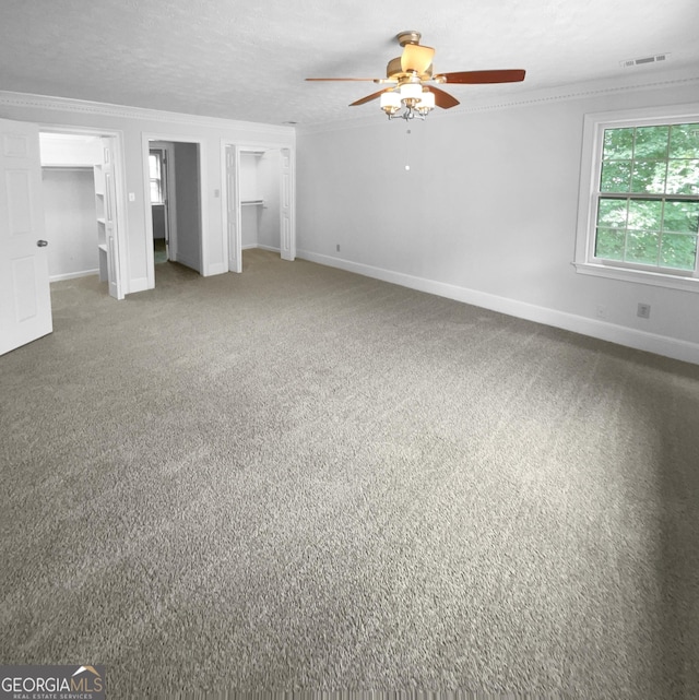 interior space with carpet, a textured ceiling, and ceiling fan