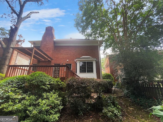 back of house featuring a wooden deck