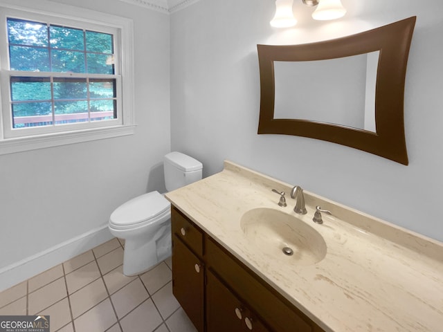 bathroom with toilet, vanity, and tile patterned floors