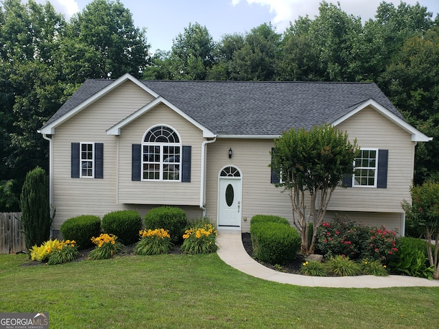 split foyer home with a front lawn