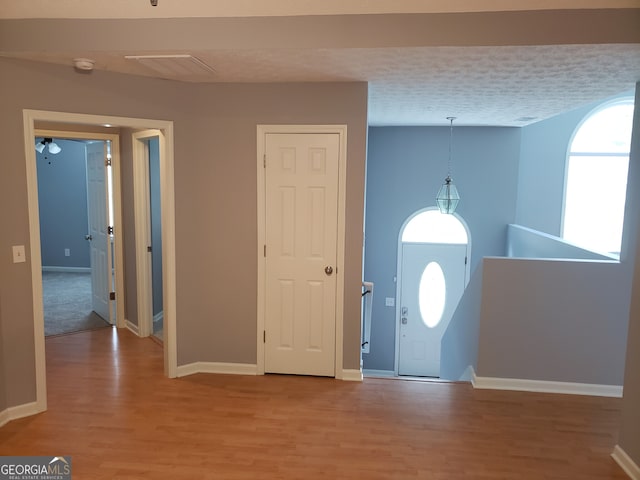 entrance foyer featuring hardwood / wood-style floors and a textured ceiling